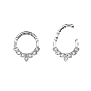 Close-up of hinged stainless steel septum ring with seven clear cubic zirconia stones