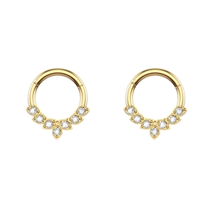 Macro view of gold-plated hinged segment rings with sparkling fan-shaped zircon stones