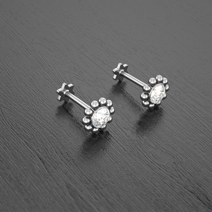 Macro view of silver floral stud with cubic zirconia and star-shaped flat back screw
