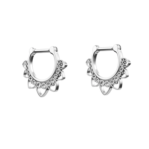 Macro detail of silver heart septum clicker with hollow ornate filigree patterns