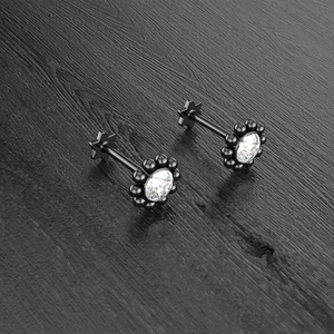 Macro view of black flower stud earring with clear zircon and star flat back detail