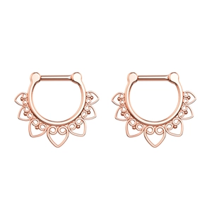 Detail of rose gold septum clickers with hollow heart patterns and bohemian engraving