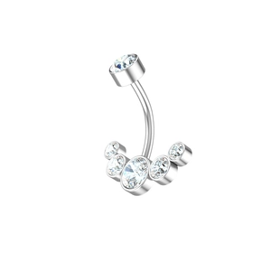 Macro detail of silver stainless steel belly ring with six bezel-set cubic zirconia stones