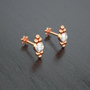 Detailed view of rose gold Czech crystal stud earrings with decorative metal beads and star back