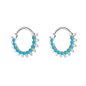 Detail of silver steel clicker rings with turquoise beads and zircon gemstones