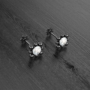 Detail view of flower labret piercing with black metal finish and clear crystal inlay