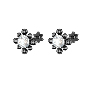 Macro detail of black piercing studs with zircon inlay and star-shaped flat back base