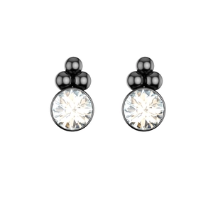 Macro shot of stylish ear studs featuring a clear round stone with black metallic spheres