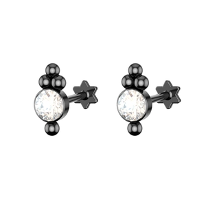 Macro shot of black steel cartilage studs with star screw backs and clear round crystals