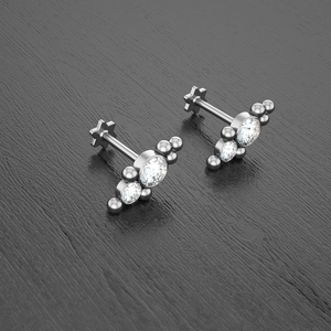 Detail of silver labret studs with three gradient crystals and star flat back base