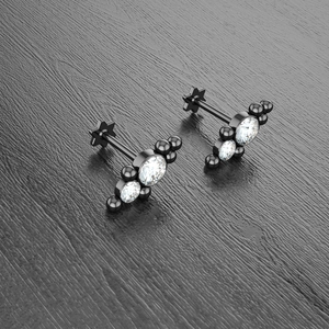 Close-up of black surgical steel star ear studs with clear cubic zirconia crystals