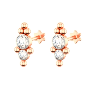 Macro detail of rose gold earrings with double round stones and star-shaped flat backings