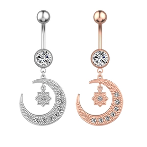 Detailed view of moon and star belly rings in silver and rose gold with cubic zirconia