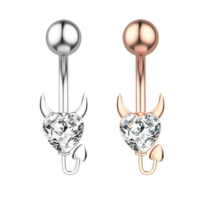 Detail view of heart zircon belly rings with devil horns and tail in silver and rose gold