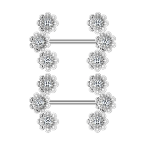 Macro view of flower-shaped nipple rings with sparkling zircon inlay on white background