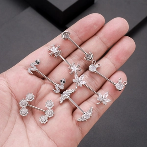 Set of 7 silver zircon nipple rings with moon, snake, and snowflake designs