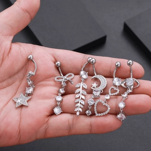 Macro view of six silver belly button rings with zircon stars, moons and hearts