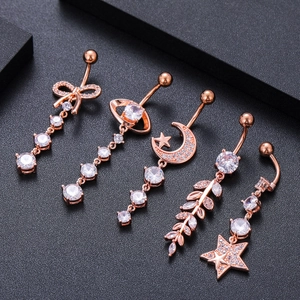 Rose gold navel rings with cubic zirconia charms in moon, star, and leaf designs