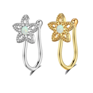 Detailed shot of non-pierced U-shaped star nose rings with center opal inlay and gold plating