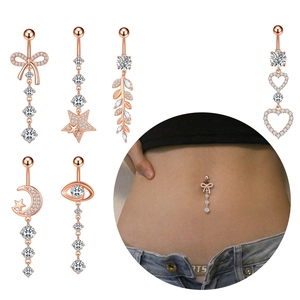 Rose gold belly ring set with zircon butterfly star and leaf dangles on white background