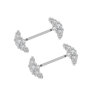 Detailed macro view of silver nipple bars with cubic zirconia in a fan shape design