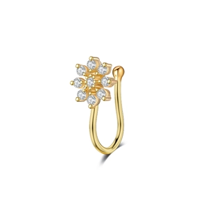 Close-up of golden floral fake nose ring with sparkling crystals and U-shaped design