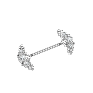 Macro shot of silver steel piercing bar with triple zircon stones and polished finish