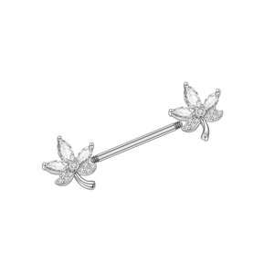 Macro shot of silver barbell nipple piercing with leaf motifs and sparkling zirconias