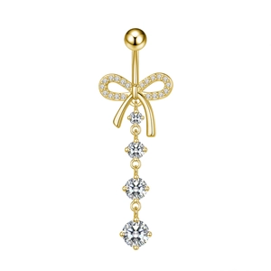 Detailed view of golden bow belly ring with cascading clear cubic zirconia crystals