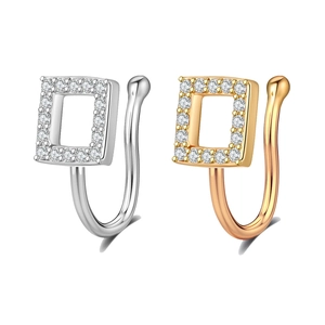 Detail of silver and gold non-pierced nose rings with square zircon crystal setting