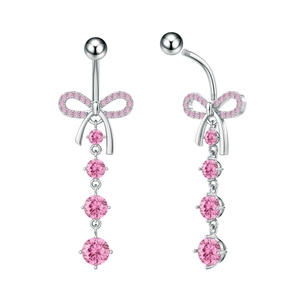 Detail view of silver belly button ring featuring pink zircon stones and a bow pendant
