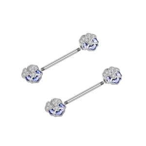 Detail of flower nipple ring with blue enamel petals and sparkling zircon stones