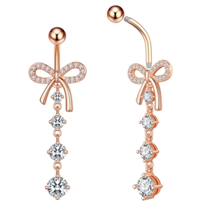 Close-up of rose gold belly button ring with zircon bow and hanging crystal stones