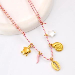 Détail du collier en cordon tressé avec breloques tortue de mer dorée et perles