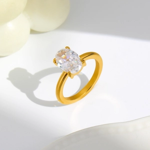Macro view of 18K gold ring featuring an oval-cut cubic zirconia in a four-prong setting