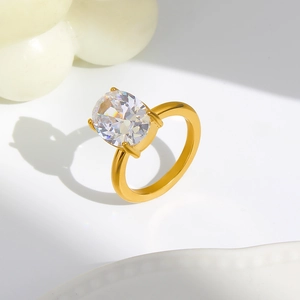 Macro shot of polished 18K gold ring with a sparkling oval cut zircon in a four-prong setting