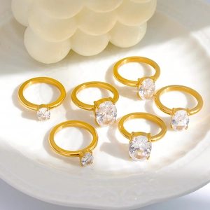 Elegant gold oval zircon ring set displayed on white ceramic plate with soft warm lighting
