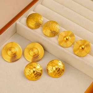 Detailed view of four pairs of vintage geometric embossed gold stainless steel stud earrings