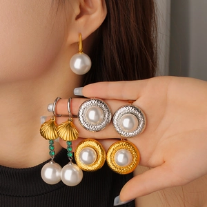 Elegant gold snake skin and pearl drop earring set for women with luxury shell details