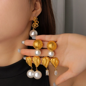 Golden snake-style pearl and gemstone earrings with vintage textured gold finish