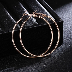 Classic large rose gold hoop earrings with polished metal finish and stud closure