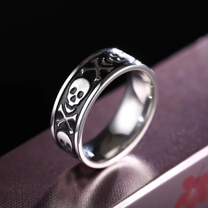 8mm stainless steel ring featuring embossed skull and crossbones with black accents