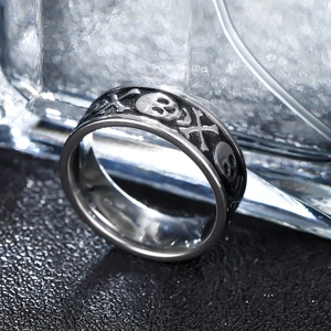 Macro shot of 8mm stainless steel punk ring featuring embossed skull and crossbones details