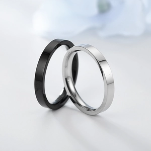 Macro shot of 3mm polished black and silver titanium steel minimalist rings for couples