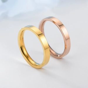 Macro shot of 6mm flat polished titanium steel rings in gold and rose gold finishes