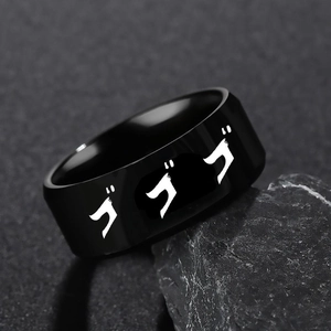 Close-up of black stainless steel JoJo ring with Japanese text on textured stone