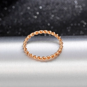 Macro detail of the twisted rope texture on a 18K rose gold plated stainless steel ring