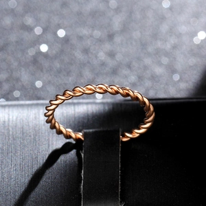 Macro shot of the twisted rope texture on a rose gold stainless steel ring for women