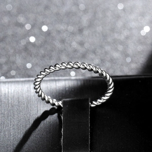 Close-up of silver twisted rope ring displayed in a black jewelry gift box