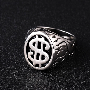 Macro shot of vintage dollar sign ring in silver finish with rock texture details